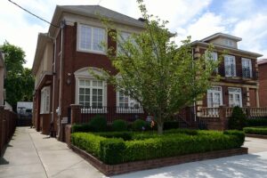 House on the corner with a well-manicured yard and curb appeal